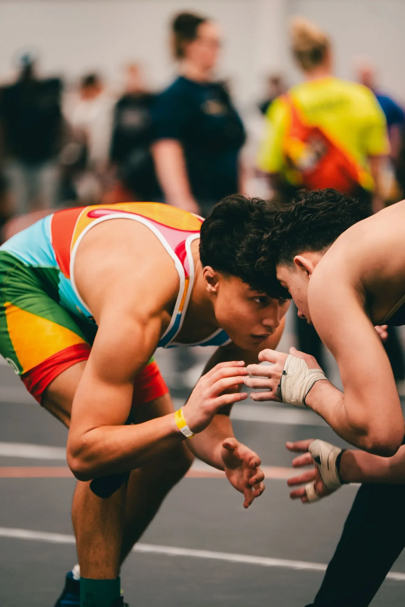 Two wrestlers hand-fighting in neutral at a tournament